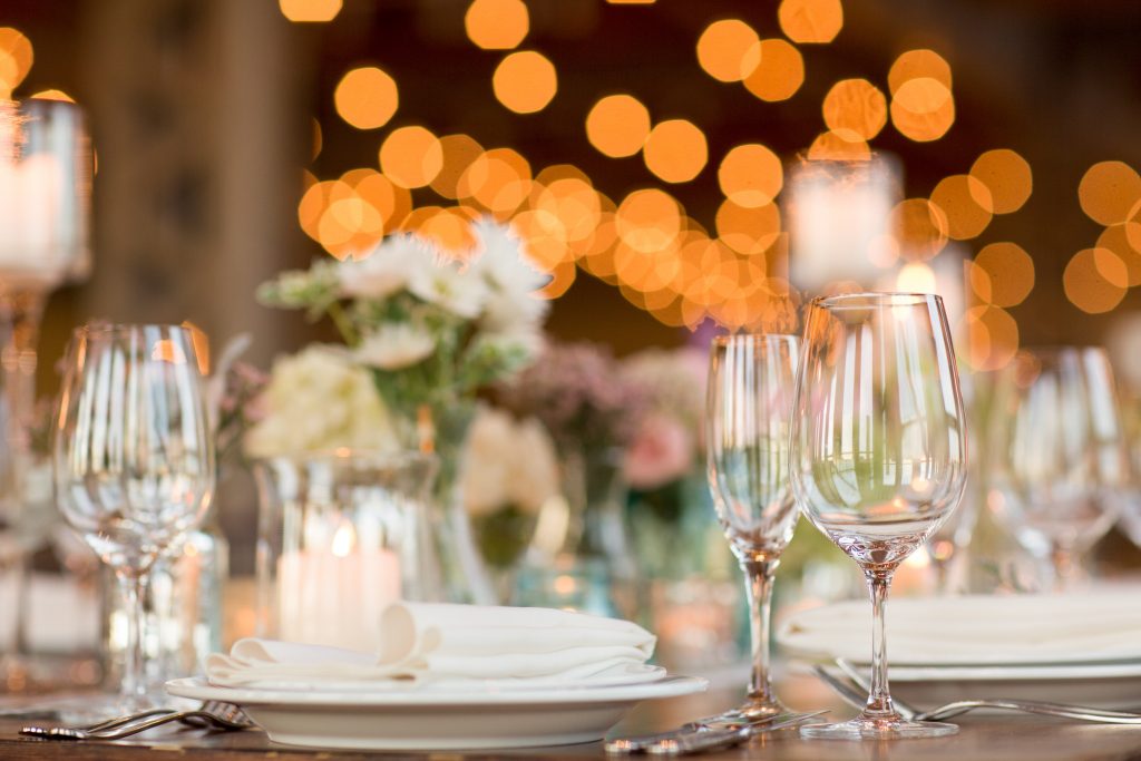 bokeh photograph of a beautifully decorated table top with empty wine glasses