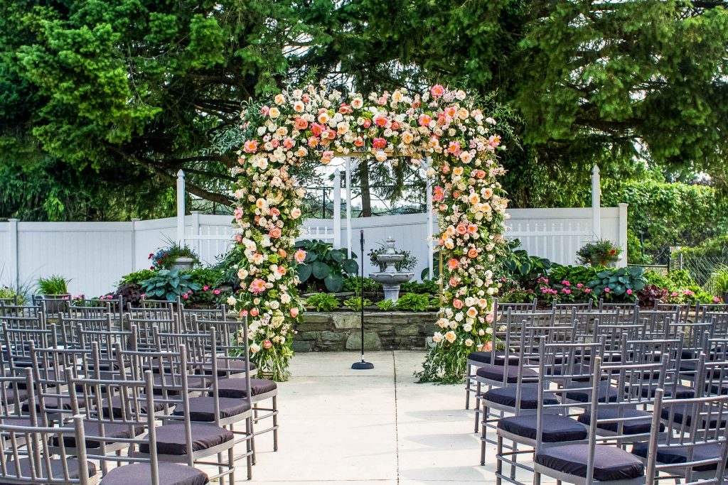 A ceremony aisle decorated beautifully with multicolored flowers